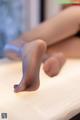 A close up of a woman's feet on a bed.