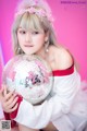 A woman holding a disco ball in her hands.